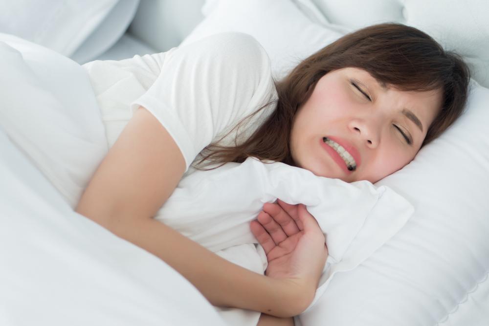girl in bed with tooth pain